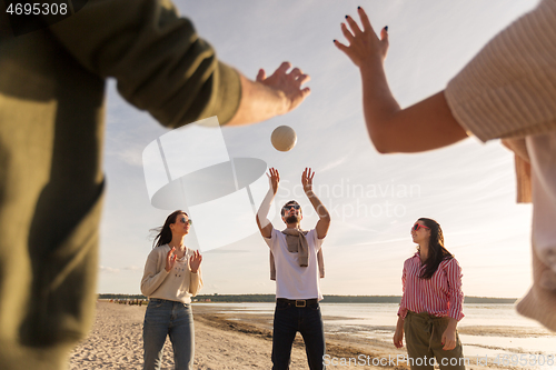 Image of friends playing volleyball on beach in summer