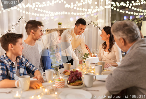 Image of happy family having birthday party at home