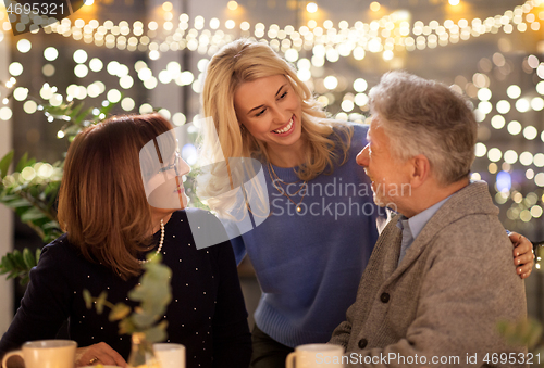 Image of happy family having tea party at home