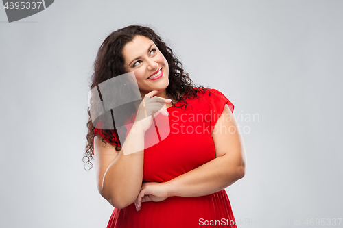 Image of happy smiling woman in red dress thinking