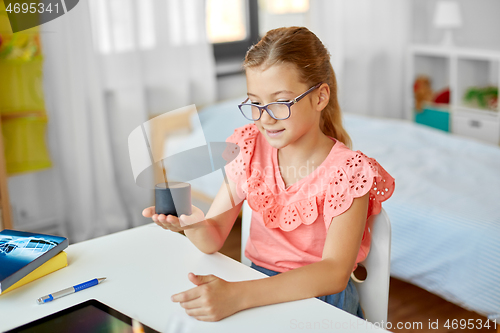 Image of student girl using smart speaker at home