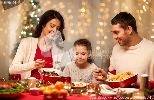 Image of happy family having christmas dinner at home