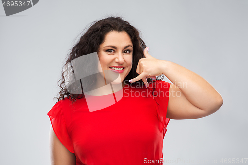 Image of happy woman showing phone call gesture