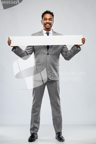 Image of smiling indian businessman with white banner