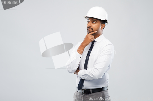 Image of indian male architect in helmet over grey