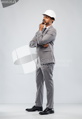 Image of indian male architect in helmet over grey