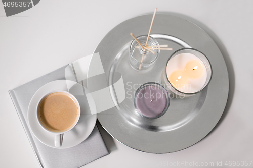 Image of coffee, candles and aroma reed diffuser on table