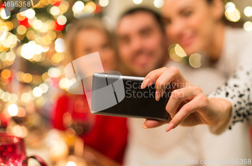 Image of close up of friends taking selfie on christmas