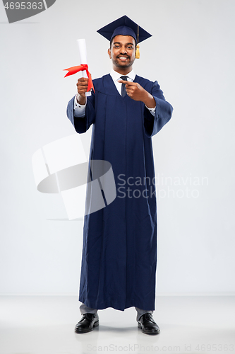 Image of male graduate student in mortar board with diploma