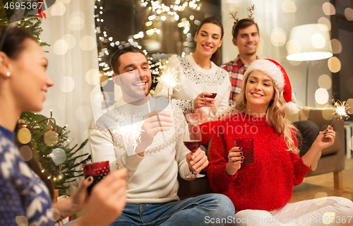 Image of friends celebrating christmas and drinking wine