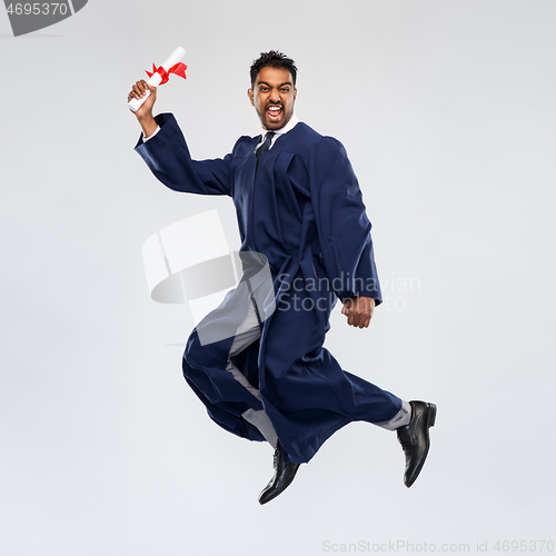 Image of happy jumping indian graduate student with diploma