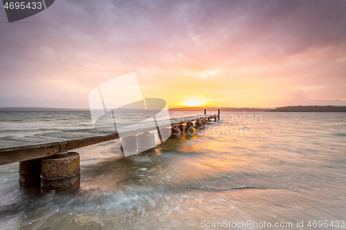 Image of Sunset sky and long timber jetty