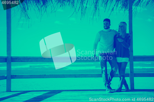 Image of Couple chating and having fun at beach bar