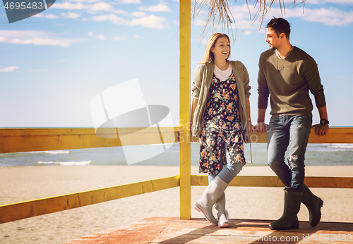 Image of Couple chating and having fun at beach bar