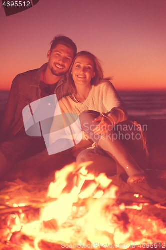 Image of portrait of young Couple enjoying  at night on the beach