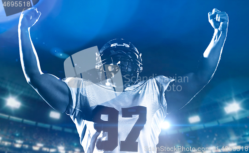 Image of american football player celebrating after scoring a touchdown