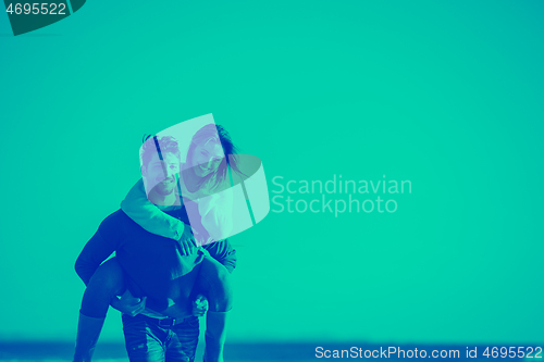 Image of couple having fun at beach during autumn