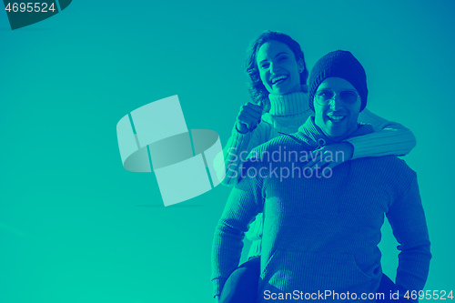 Image of couple having fun at beach during autumn