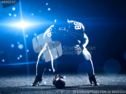 Image of American football player starting football game