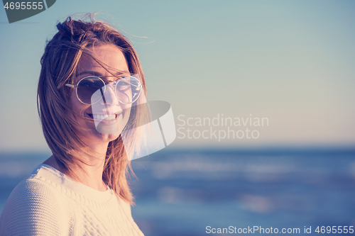 Image of Young woman enjoying the warm autumn day