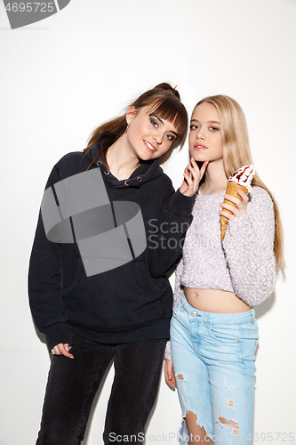 Image of Close up fashion portrait of two young pretty hipster teens