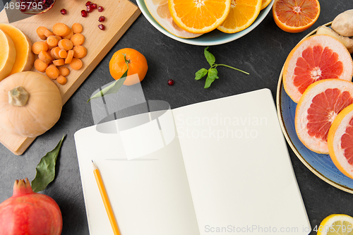 Image of close up of notebook, fruits and vegetables