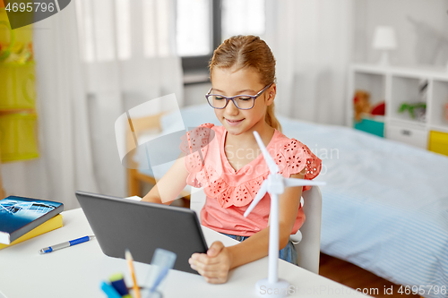 Image of student girl with tablet pc and wind turbine model