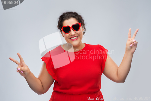 Image of happy woman in red heart-shaped sunglasses