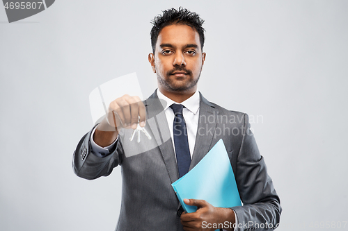 Image of indian man realtor with key and folder