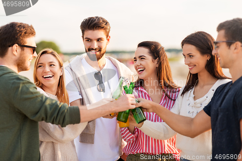 Image of friends toasting non alcoholic drinks on beach