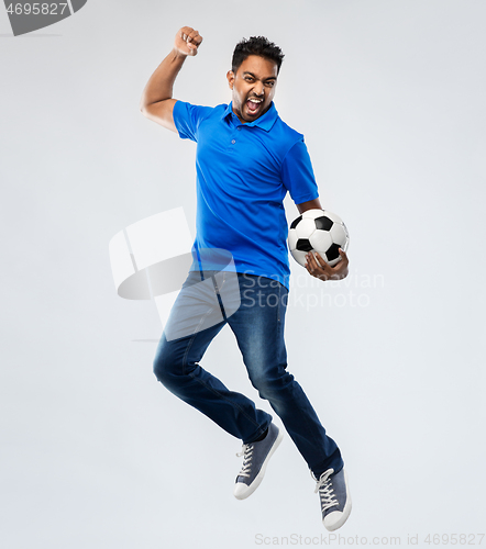 Image of man or football fan with soccer ball jumping