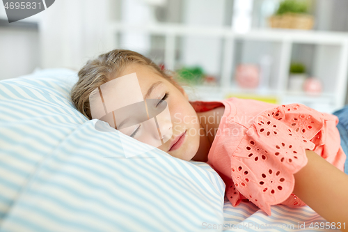 Image of little girl sleeping in her room at home