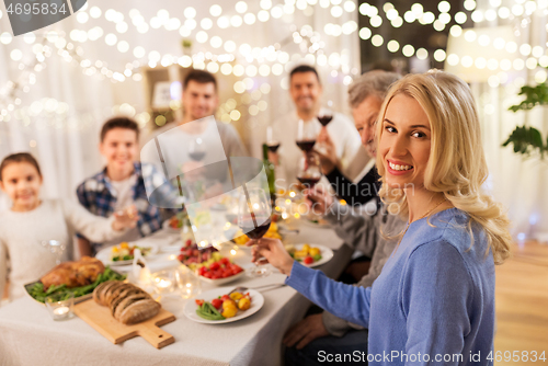 Image of happy family having dinner party at home