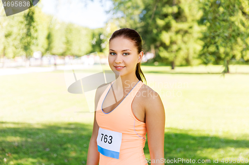 Image of woman at running marathon with badge number