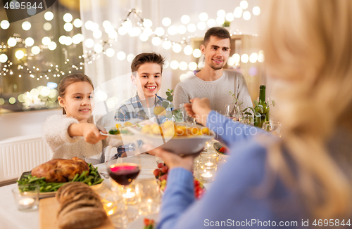 Image of happy family having dinner party at home