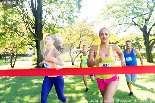 Image of happy young female runner on finish winning race