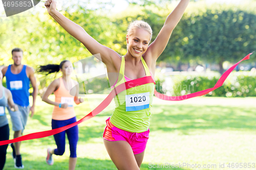 Image of happy young female runner on finish winning race