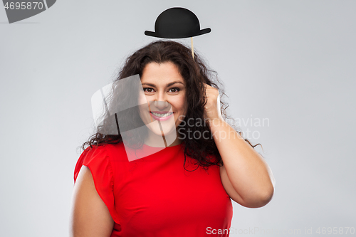 Image of happy woman in red dress with black bowler hat