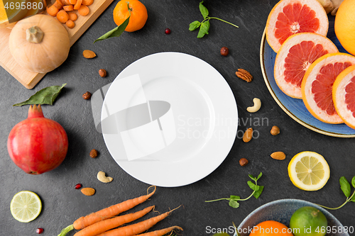 Image of plate, vegetables and fruits on on slate table