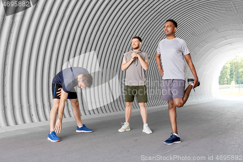 Image of men or male friends stretching before training