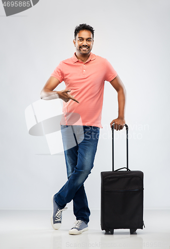 Image of smiling indian man in polo shirt with travel bag