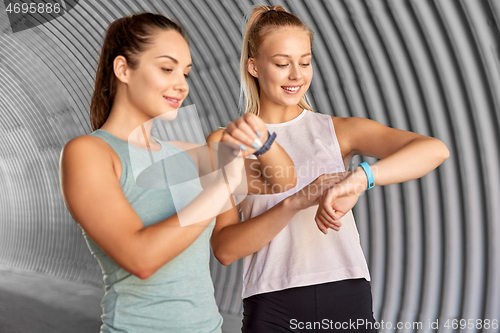 Image of women or female friends with fitness trackers