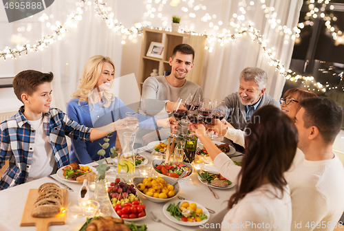 Image of happy family having dinner party at home