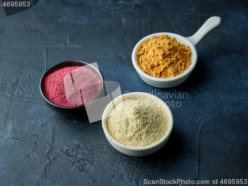 Image of three various bowls of dried plant powder