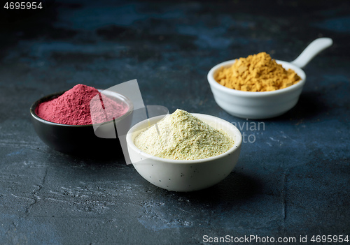 Image of three bowls of dried plant powder