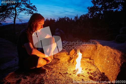 Image of Man by a campfire