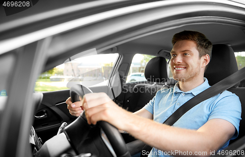 Image of smiling man or driver driving car