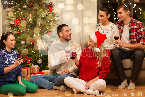 Image of friends celebrating christmas and drinking wine