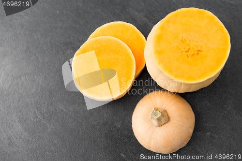 Image of cut pumpkin on stone background