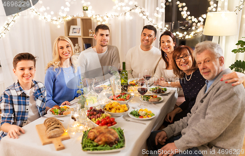 Image of happy family having dinner party at home